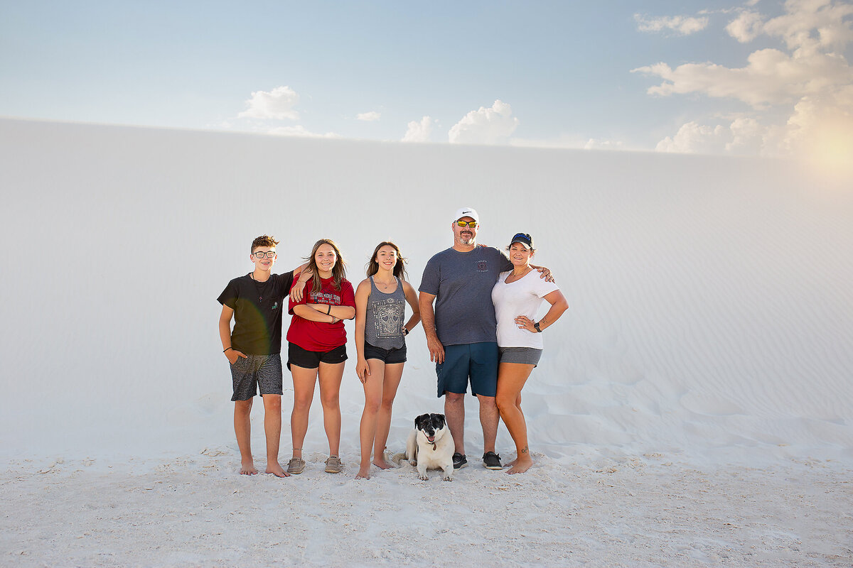 Family standing with dog at White Sands National Park NM