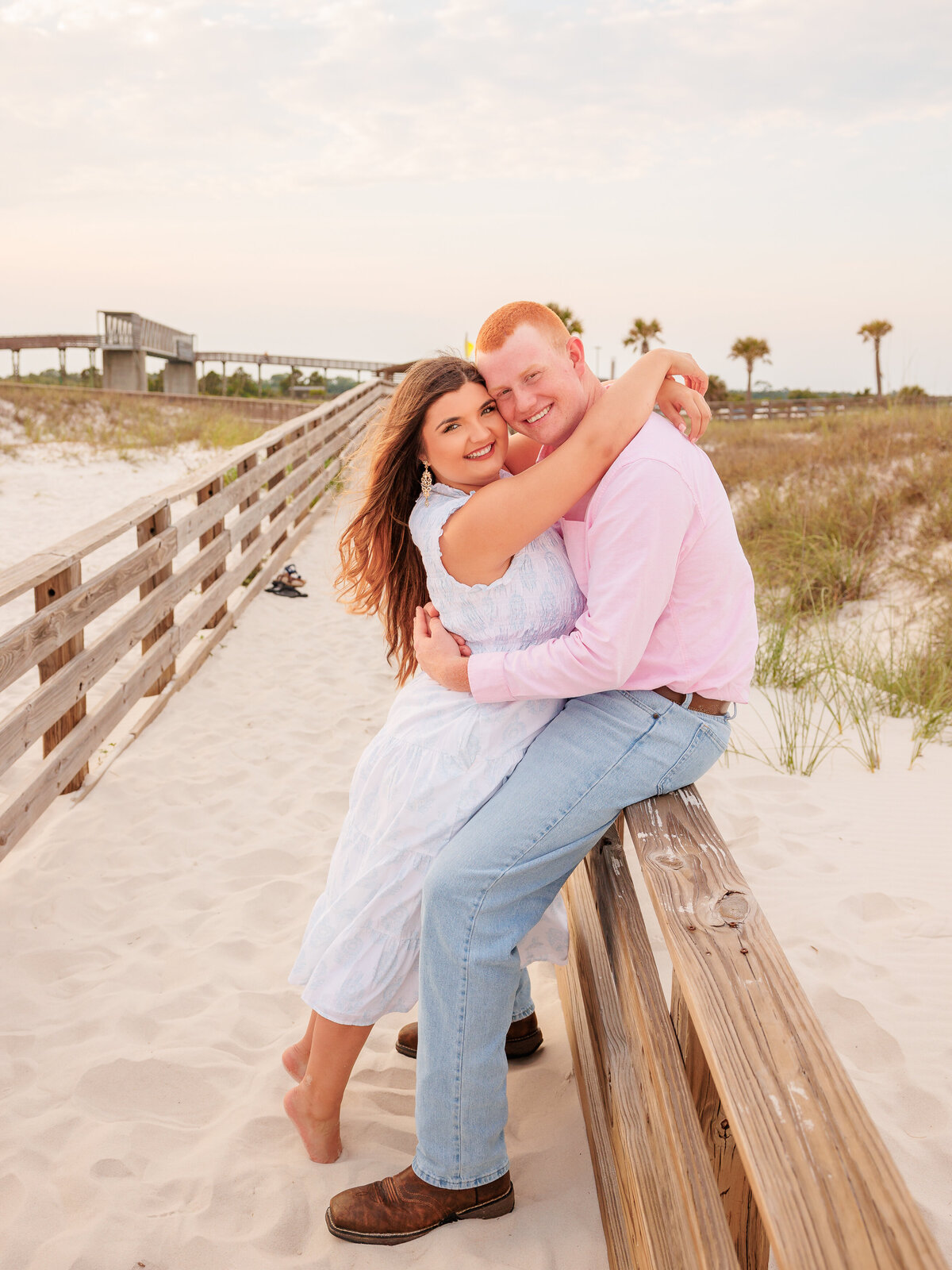 Spontaneous beach adventure for young couple with portraits on boardwalk