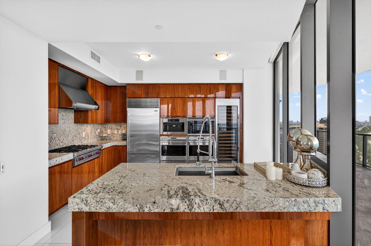 Sleek custom kitchen with chef-grade appliances and ocean views at PH-888
