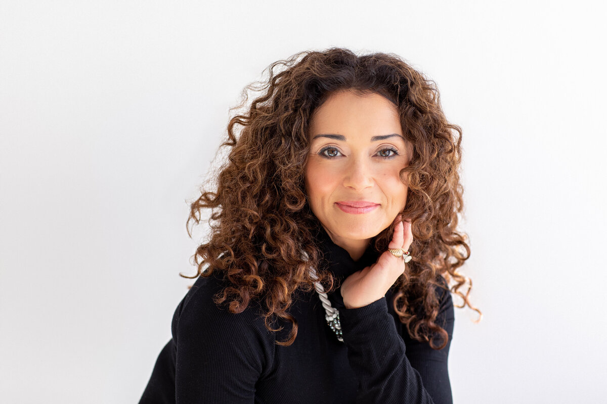 Professional woman smiling in a bright studio Philadelphia headshots session