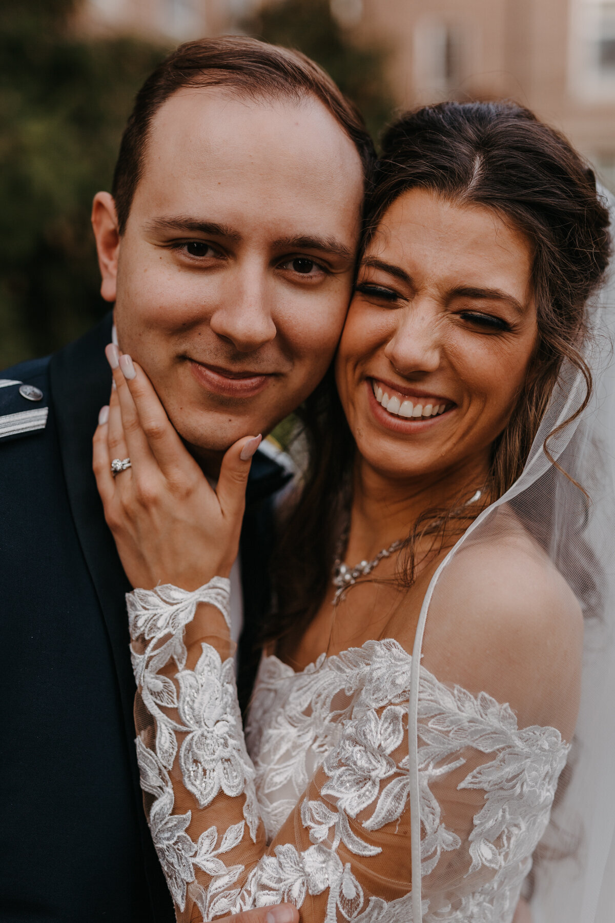 close up portrait of bride and grooms faces next to each other
