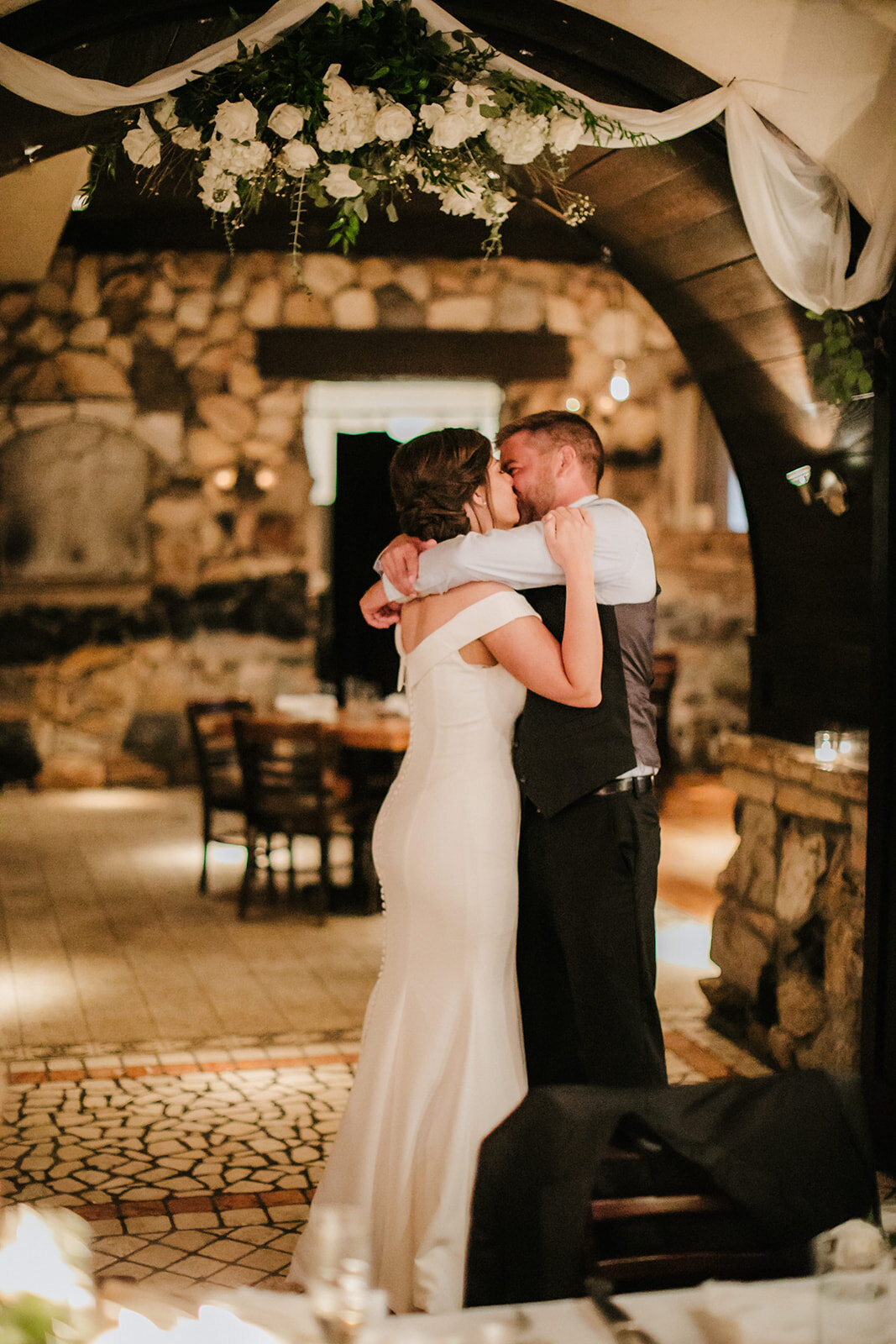 Bride and groom kiss  at Osteria Via Stato Chicago wedding