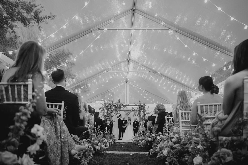 wedding ceremony with clear top tent and string lights