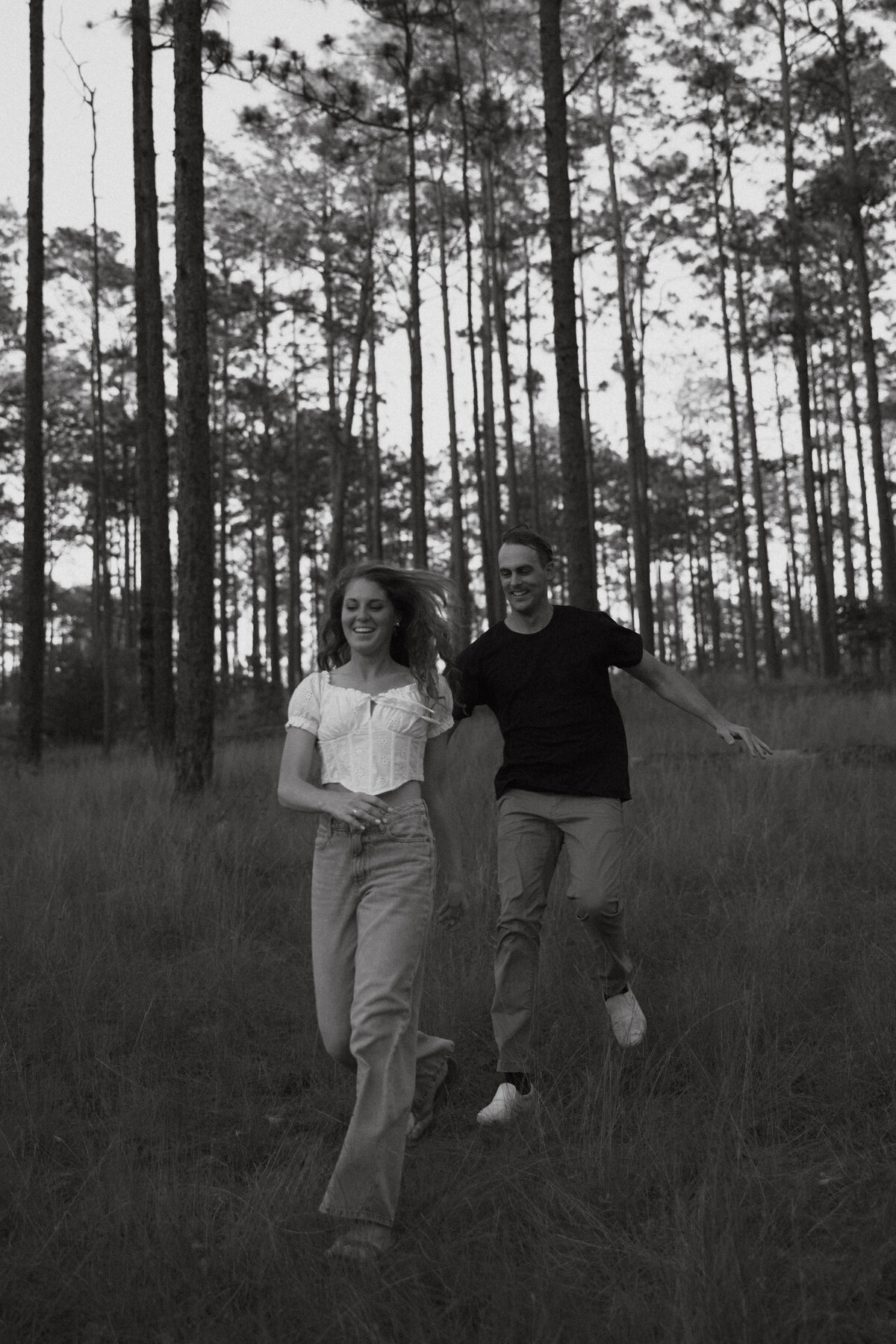 Couple posing for portraits in a forest.