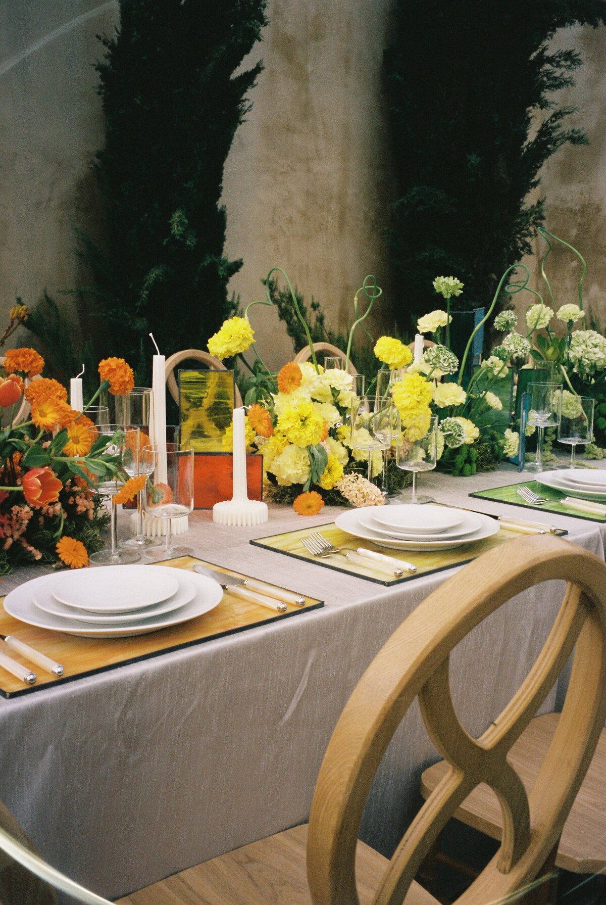 A table is set with colored flowers