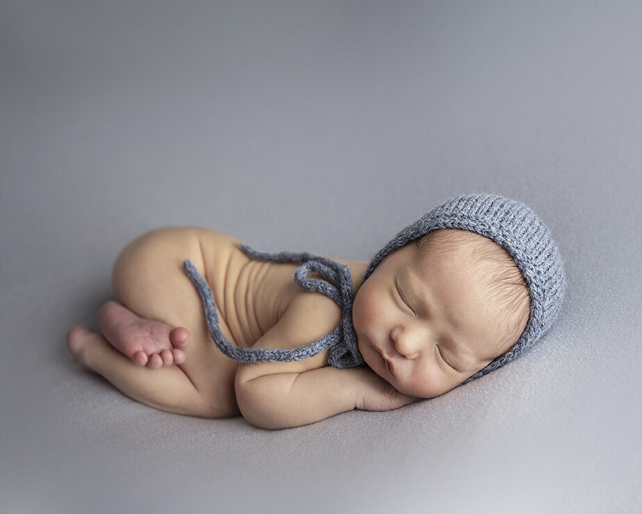 blue hat posed newborn