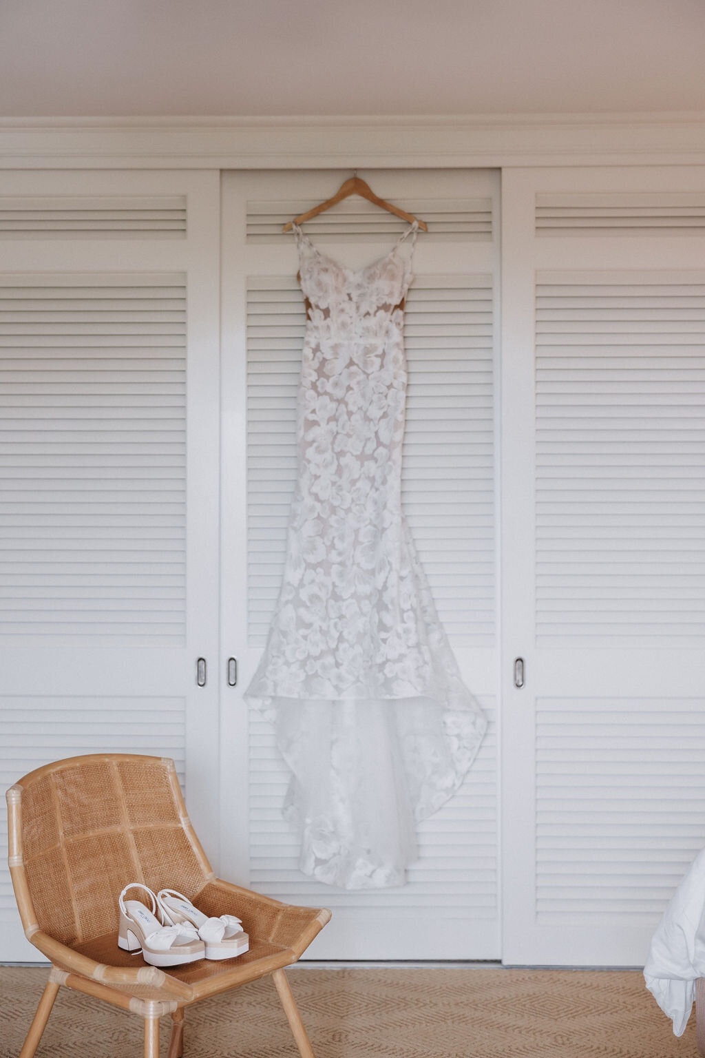 Detail photo of dress  hanging and shoes sitting on a wicker chair at four seasons oahu