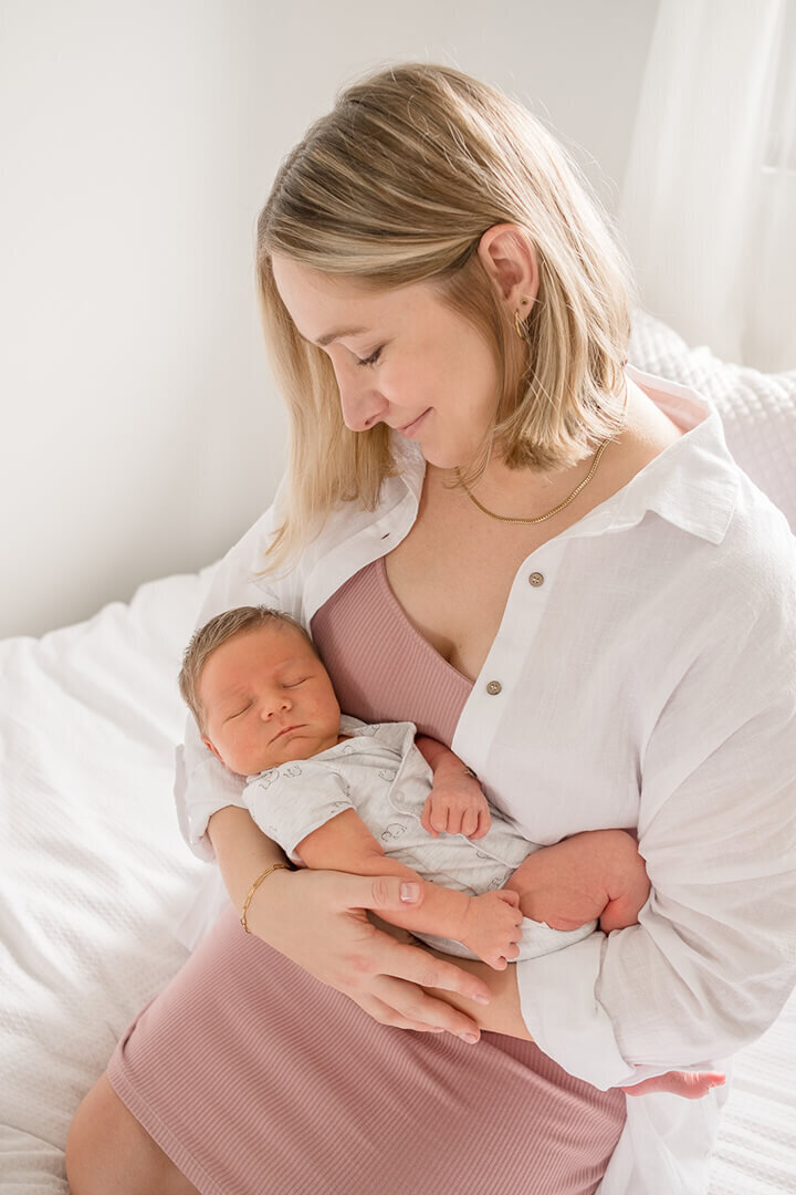 newborn boy sound asleep in mums arms during newborn maternity photoshoot session gold coast