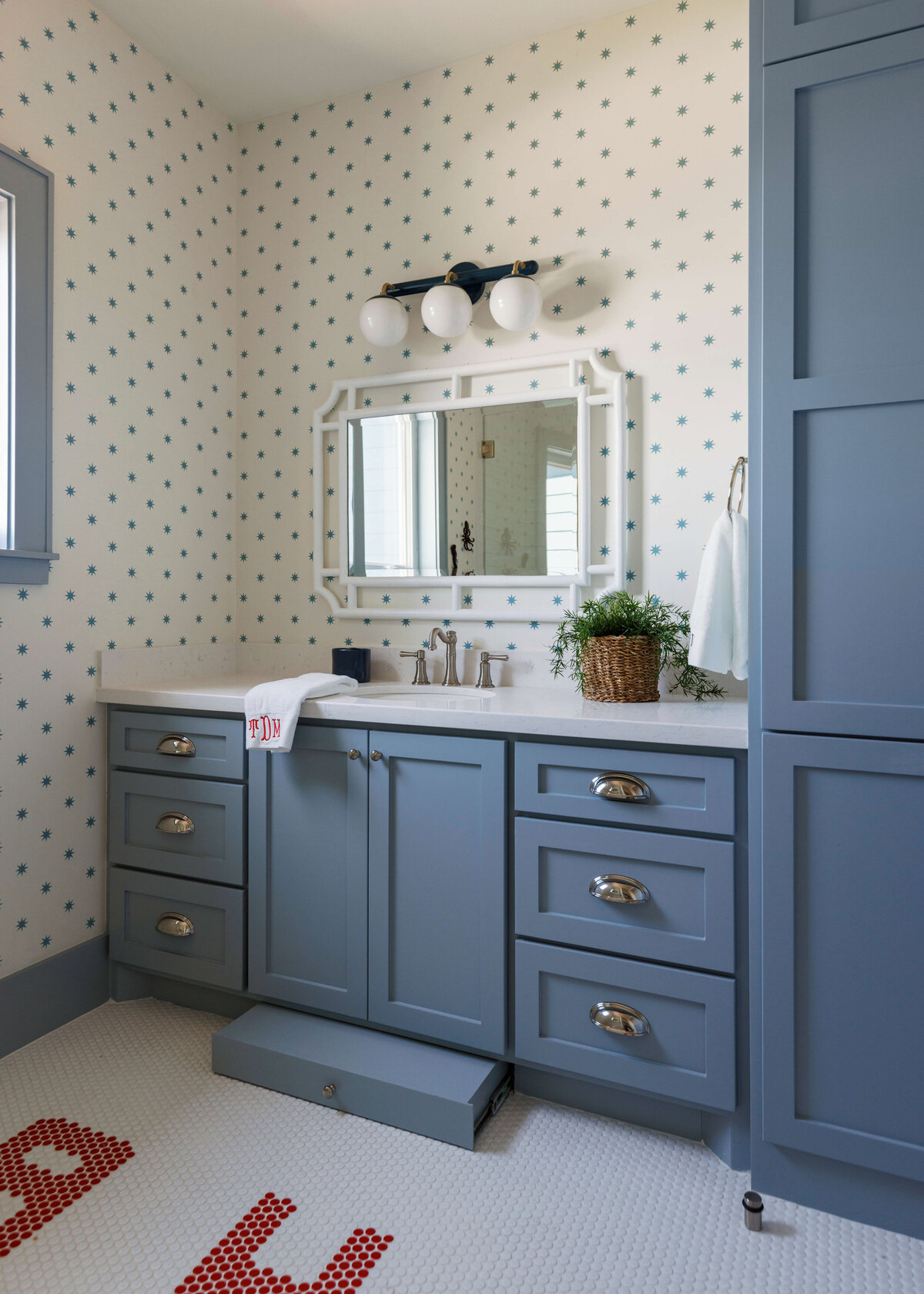 oyster creek studios lighthouse on the lake blue vanity with star pattern wallpaper in bathroom