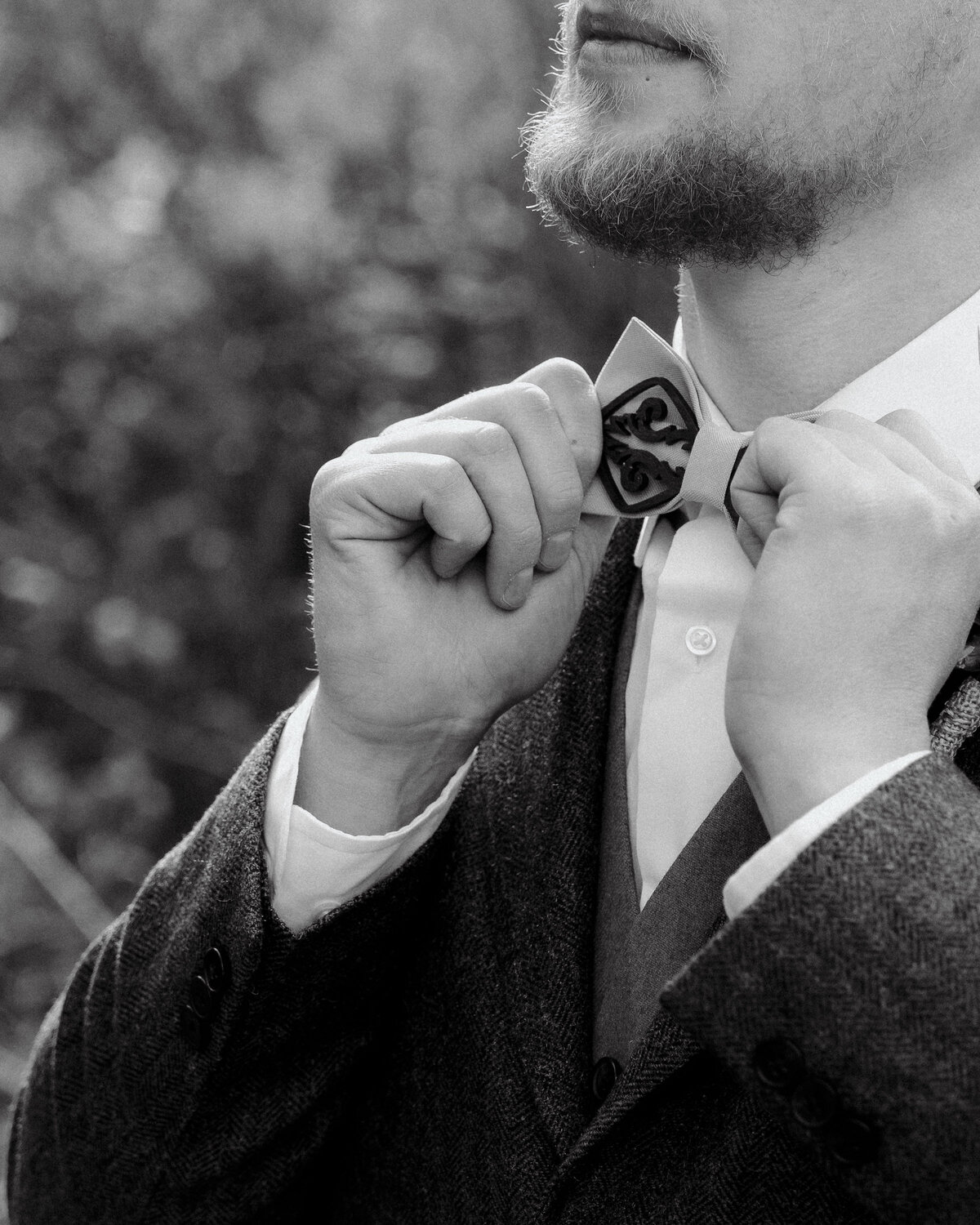 man adjusting bowtie