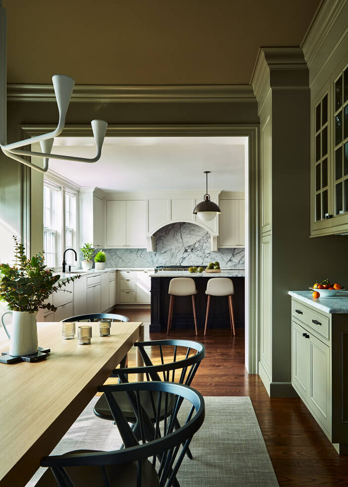 A Boston kitchen designer blends modern dining room furniture with a sleek kitchen design, creating a seamless and stylish open-concept space.