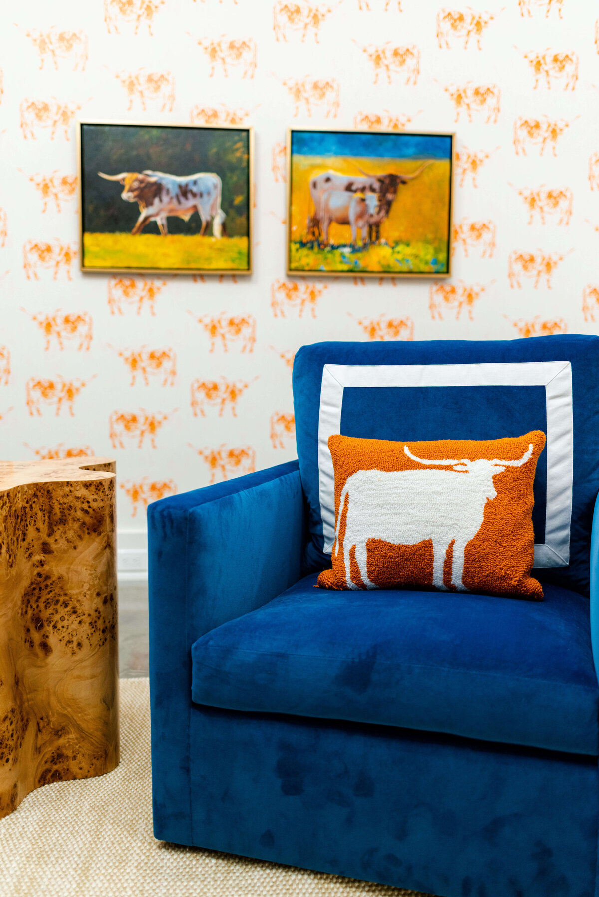 oyster creek studios building belt new build orange cow wallpaper with cow paintings and cow orange cow pillow on blue chair