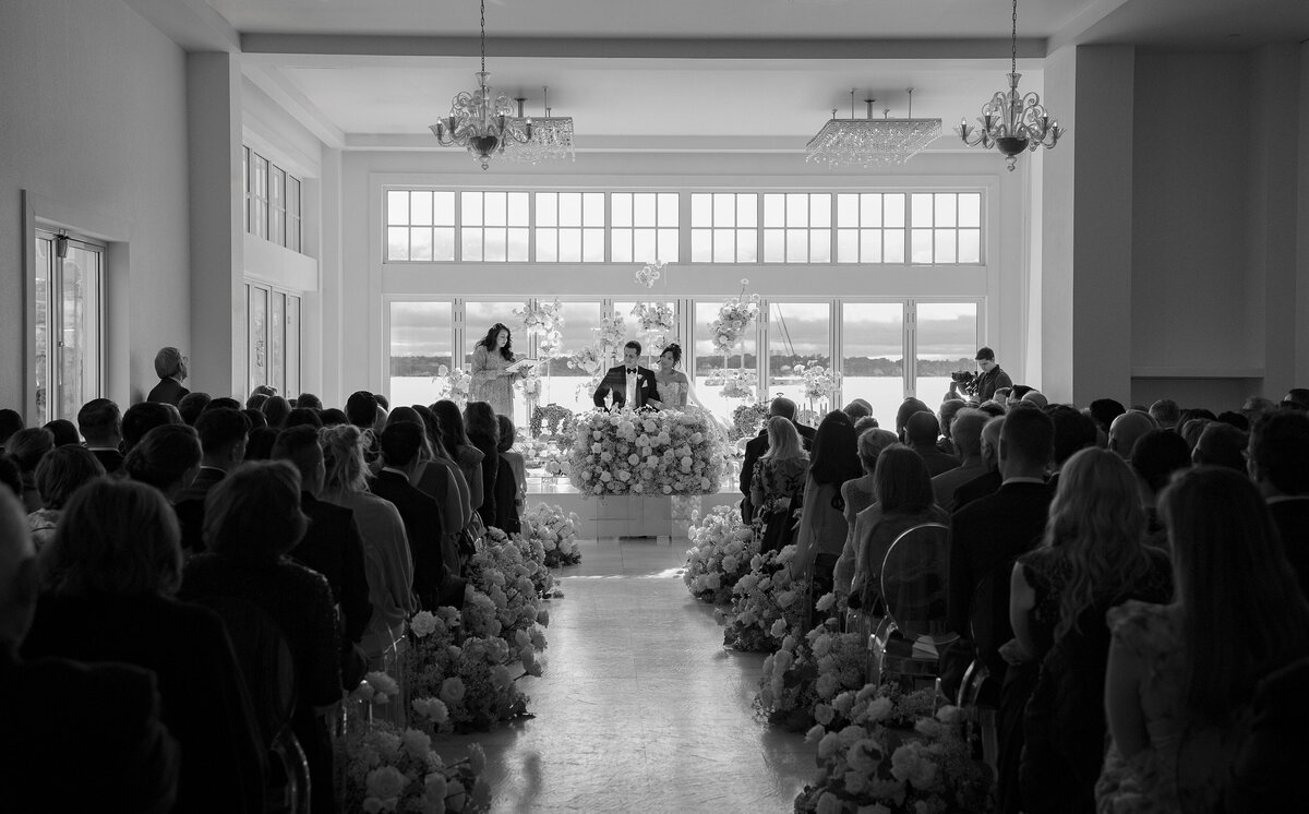 Bride and Groom sit at Sofreh Aghd during Persian wedding ceremony at Belle Mer, Newport.