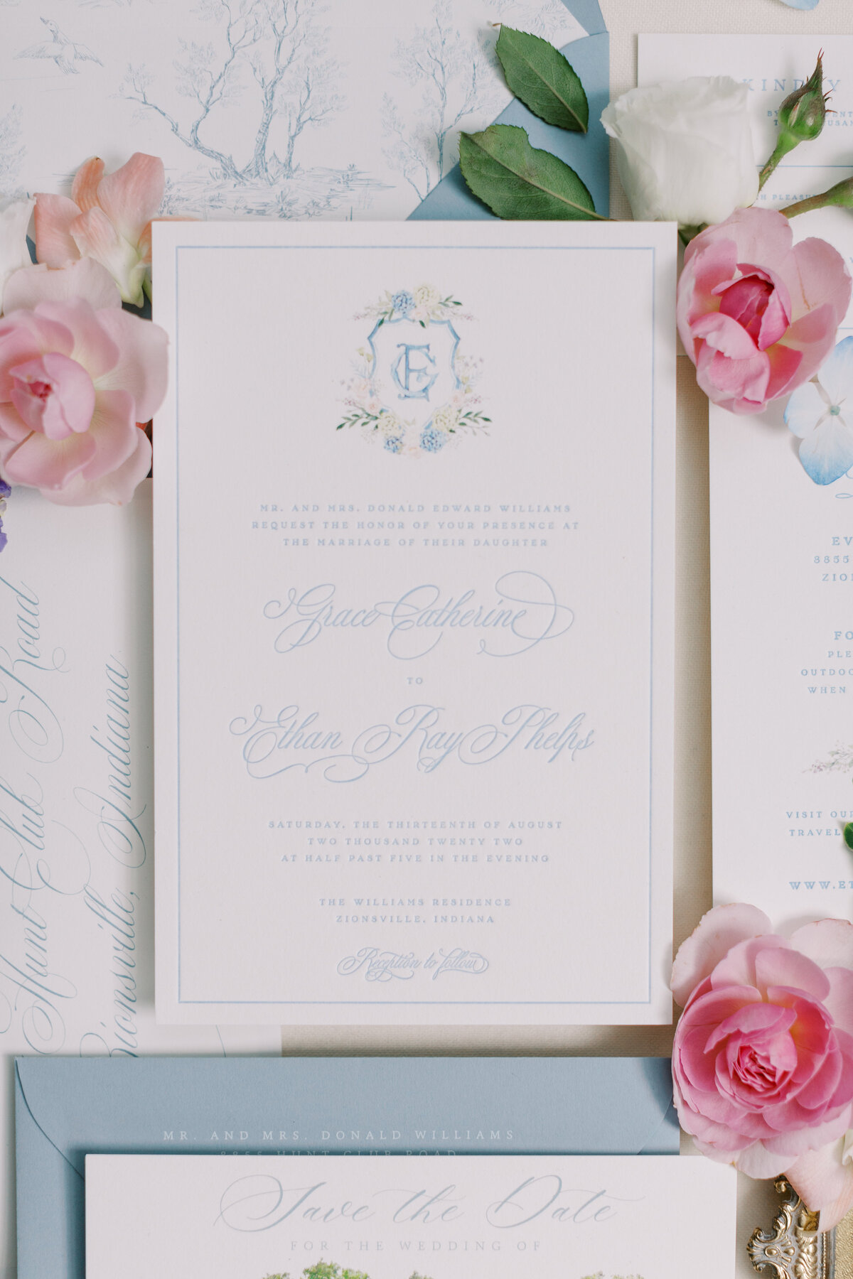 Beautiful blue themed wedding invitations with a wedding crest