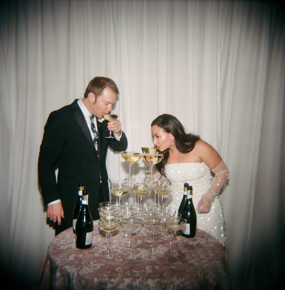 champagne tower on holga film with bride wearing gloves