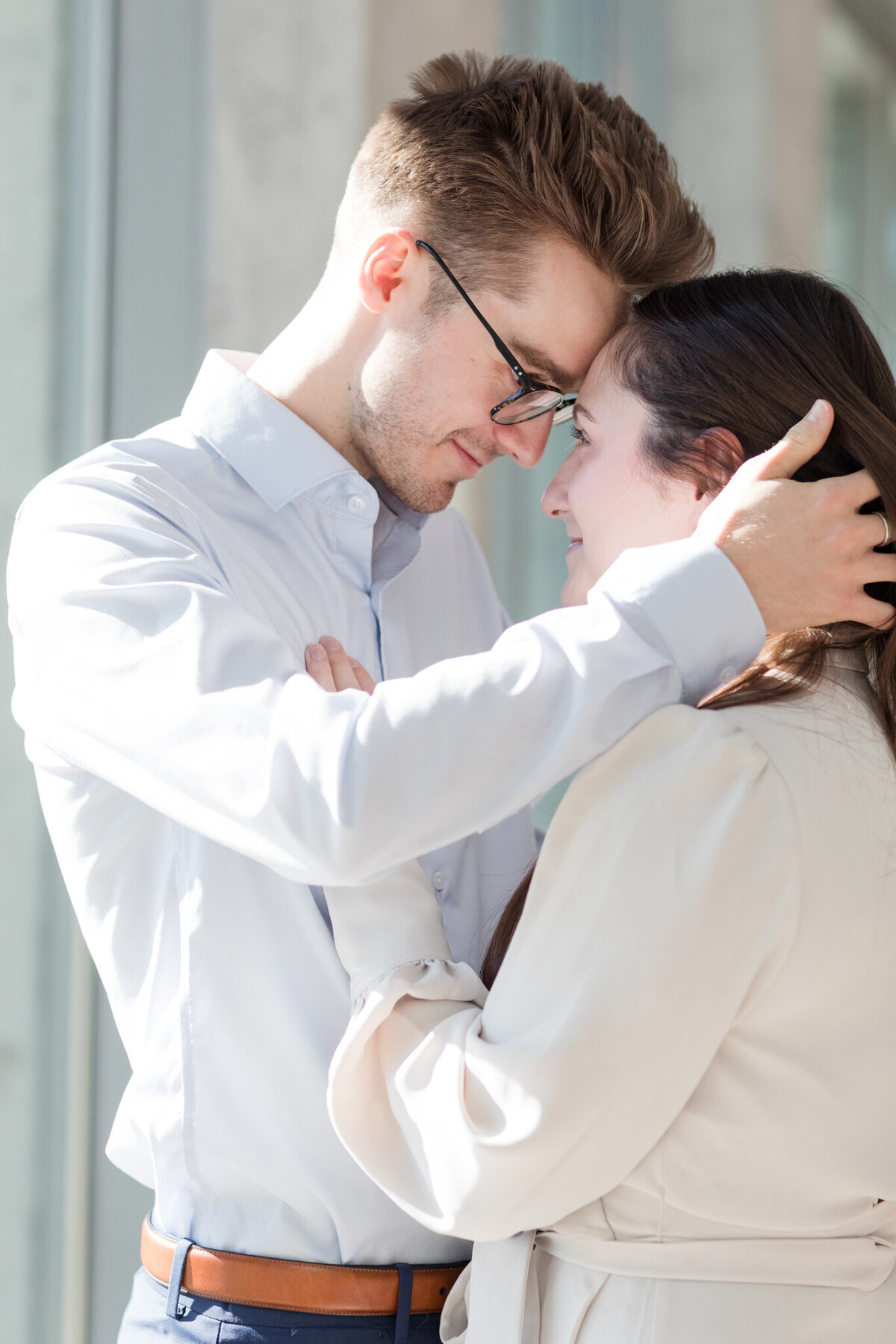 In a close-up portrait, Yannick gently brushes Melissa's hair away, their eyes locked in a tender gaze, reflecting the depth of their bond
