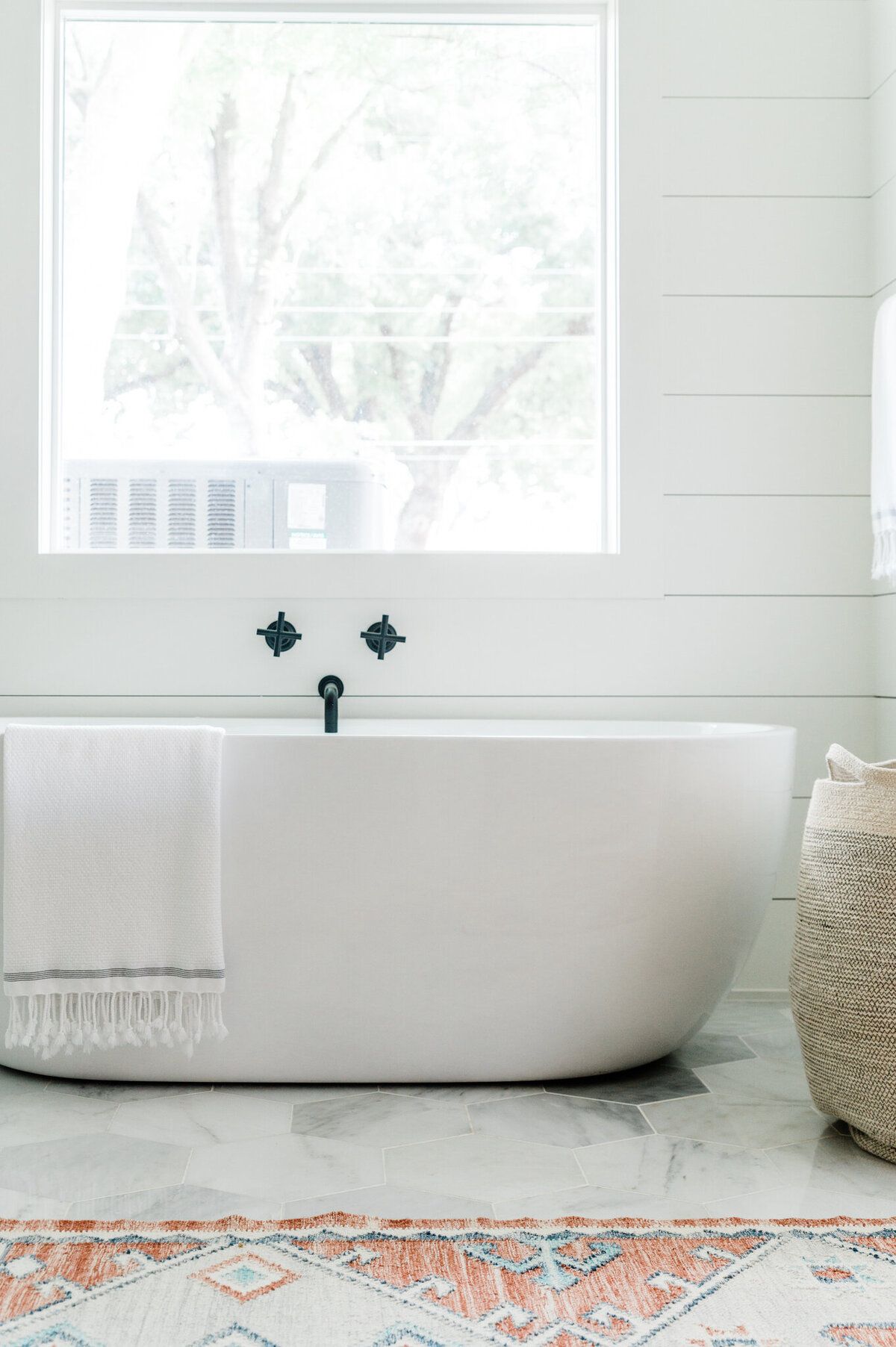 Large tub in a well designed farmhouse style bathroom