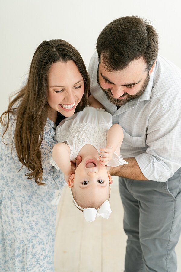 Parents dipping one year old for Louisville Portrait Photography session