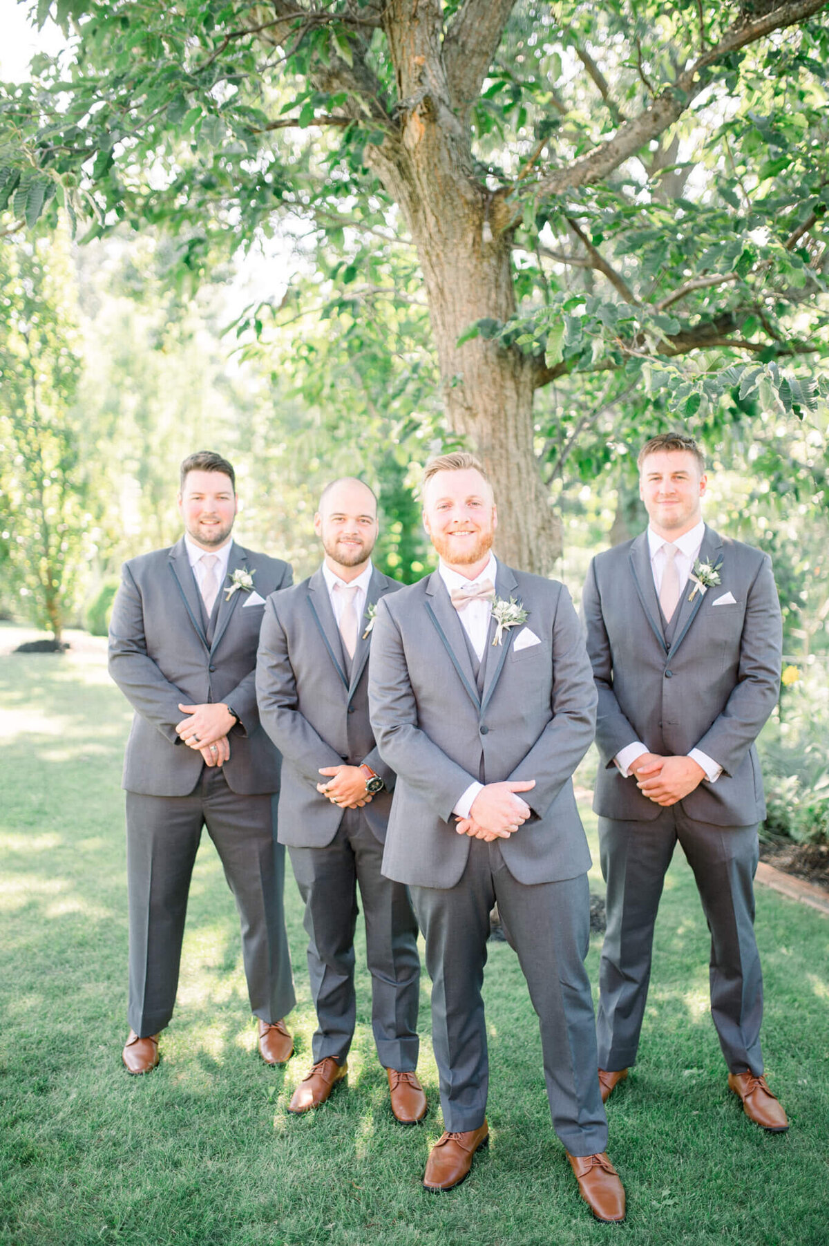 Groom standing at the front of the  V for groomsmen portrait