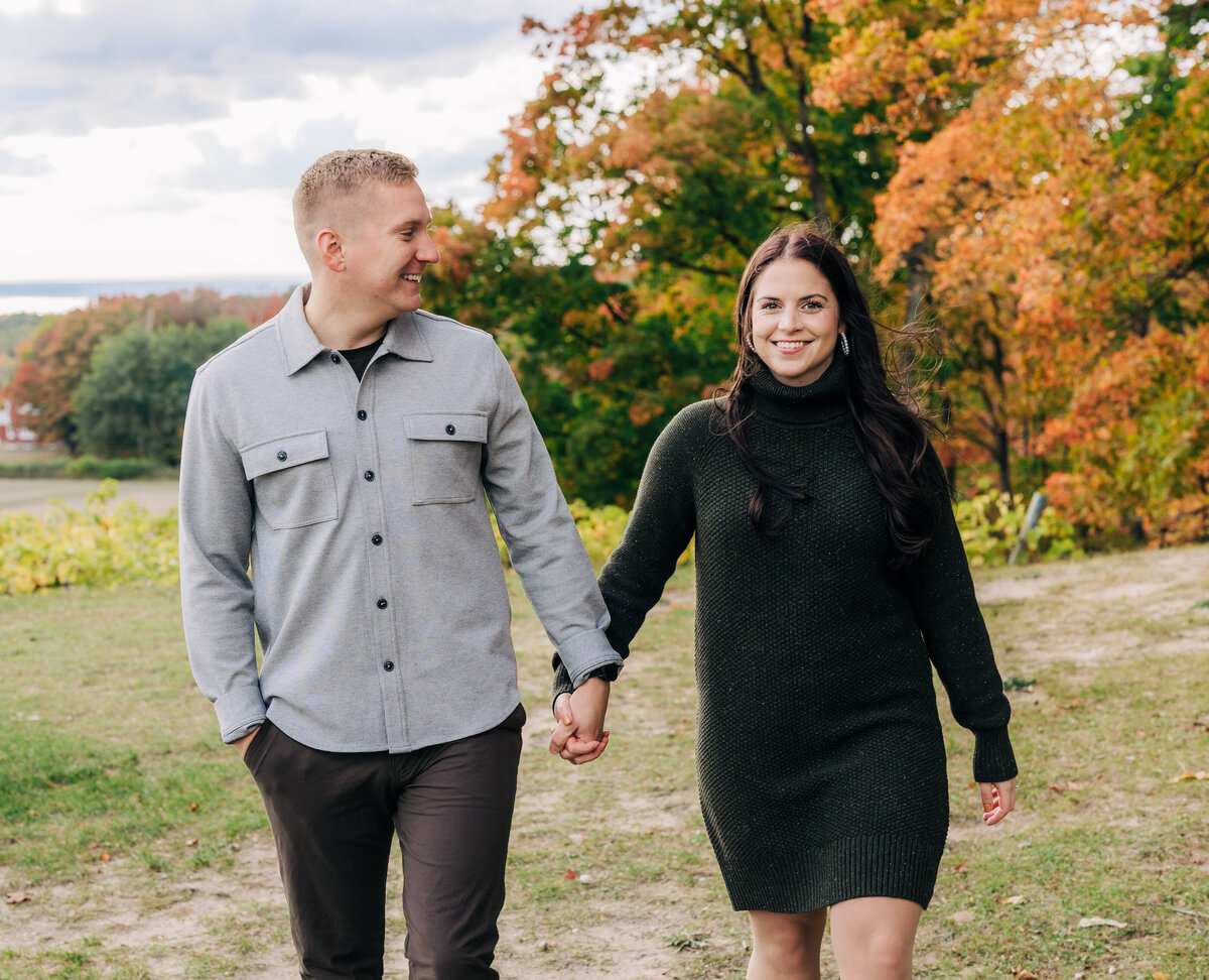 Couple holding hands for fall engagement session