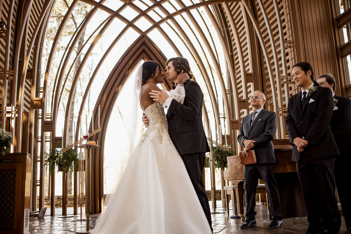 bride and groom share a kiss