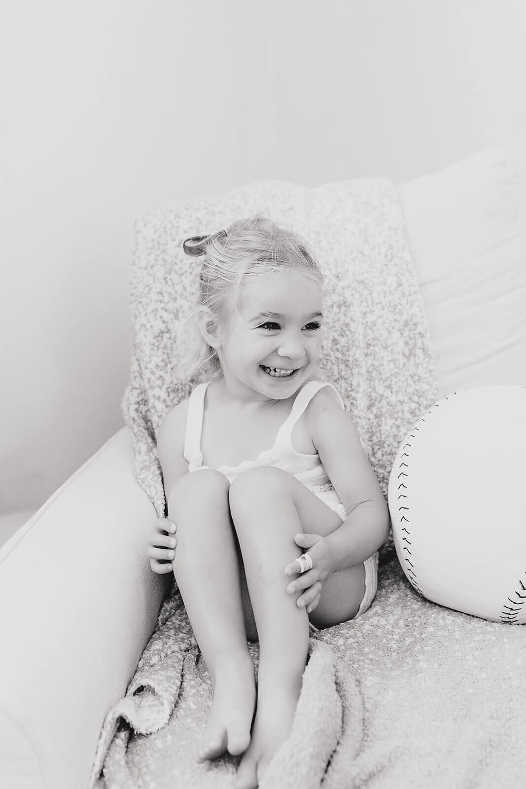 Natural newborn portraits in Bay Area home using soft, neutral tones.