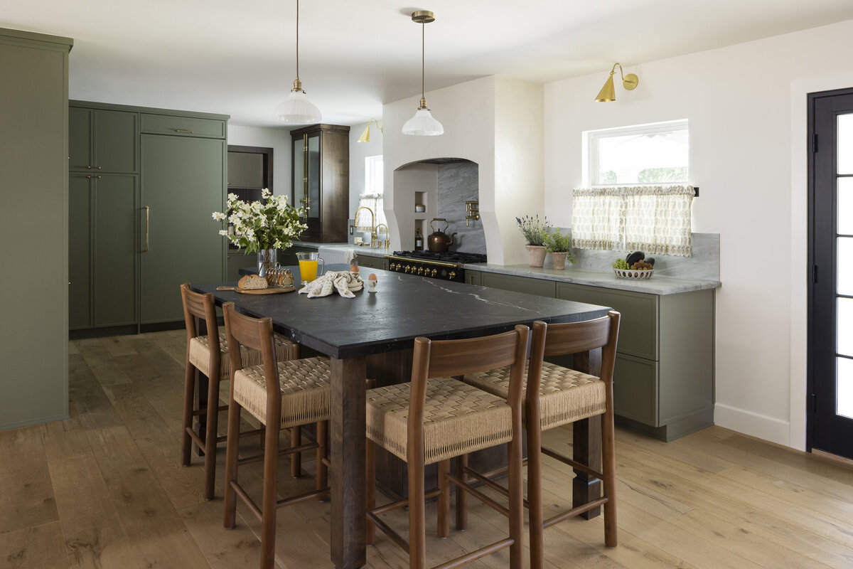 Tustin kitchen renovation. Green shaker cabinets with  stained kitchen island with  marble countertop.