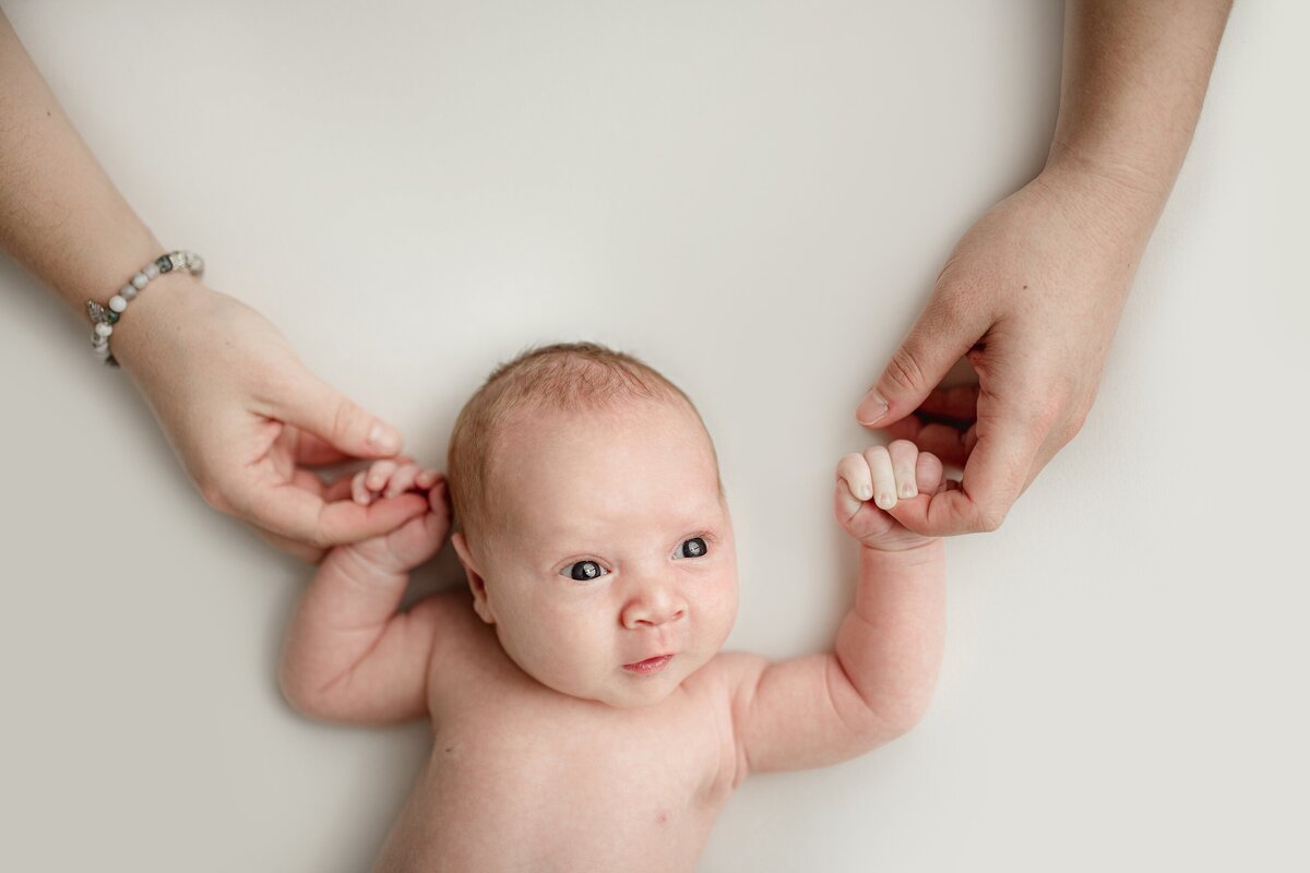 newborn-baby-holding-moms-hands