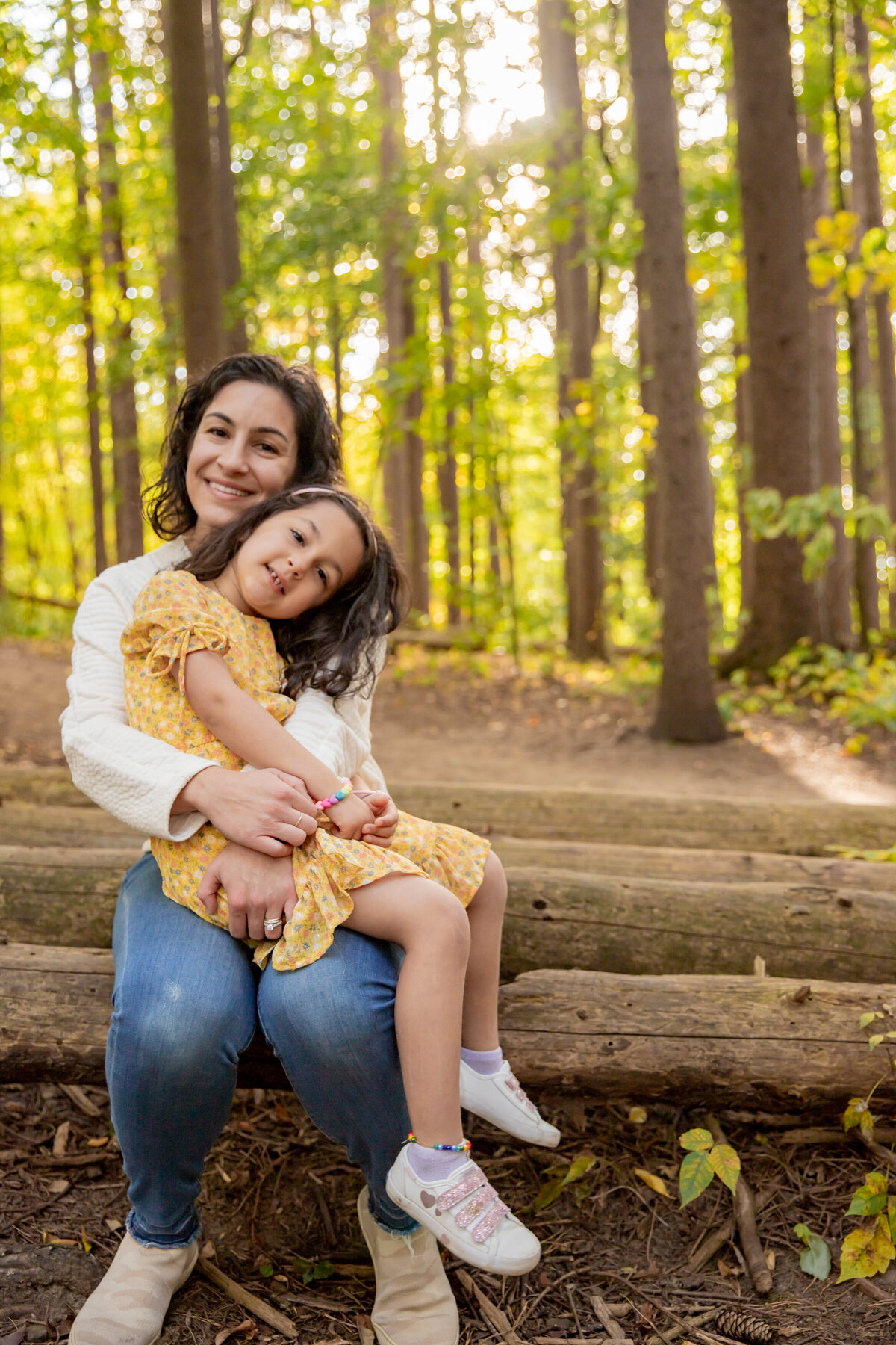 mother-daughter-sitting-log-saginaw-forest