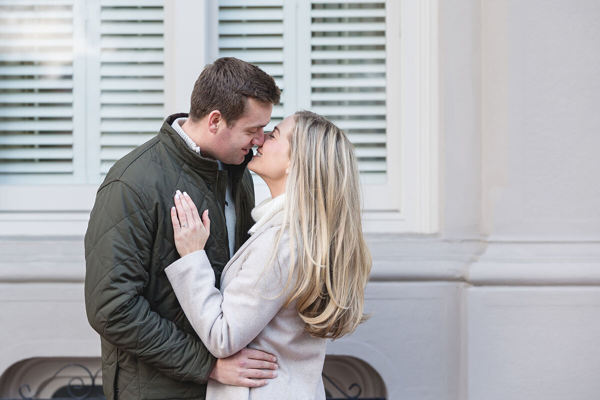 An egaged couple goes to share a kiss during their engagement session in  Beacon Hill