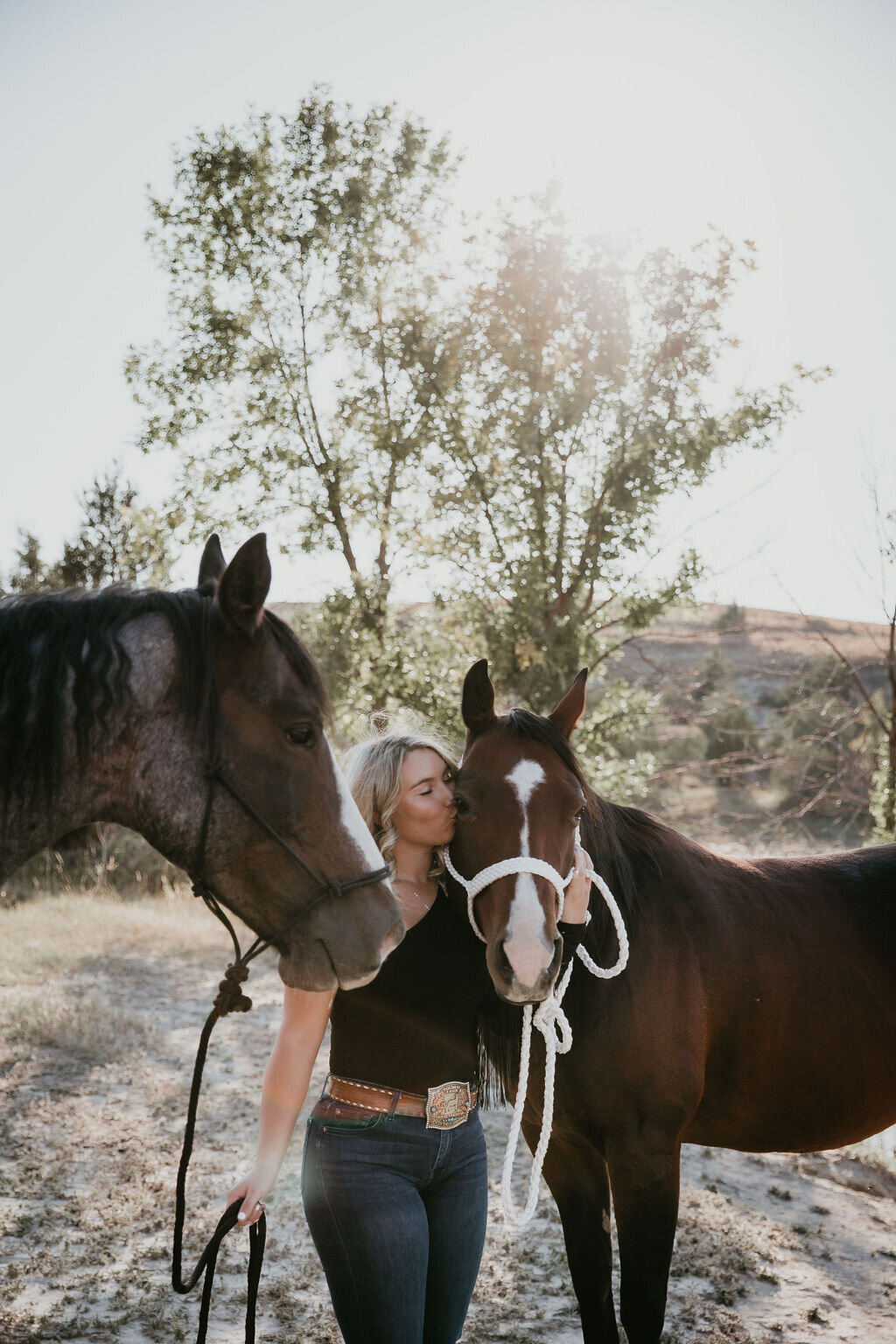 Portrait of young woman with horses