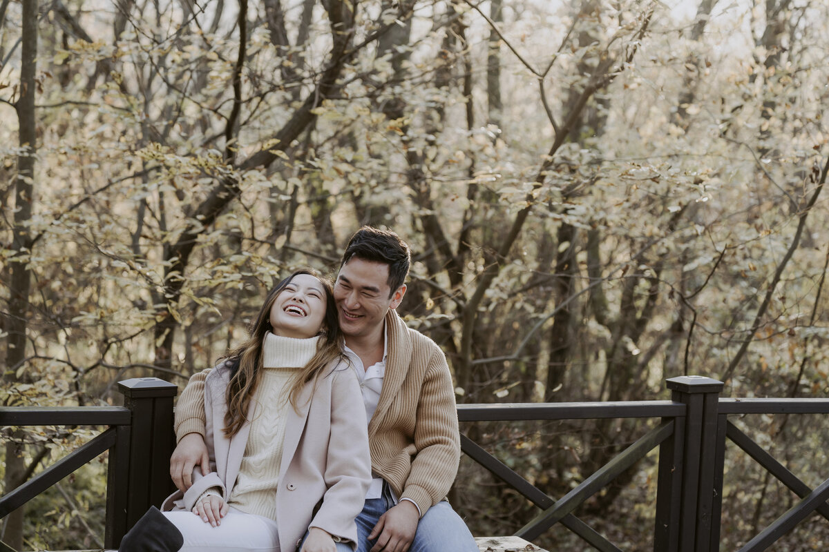 the couple sitting while laughing on the bench of the eco park in damyang