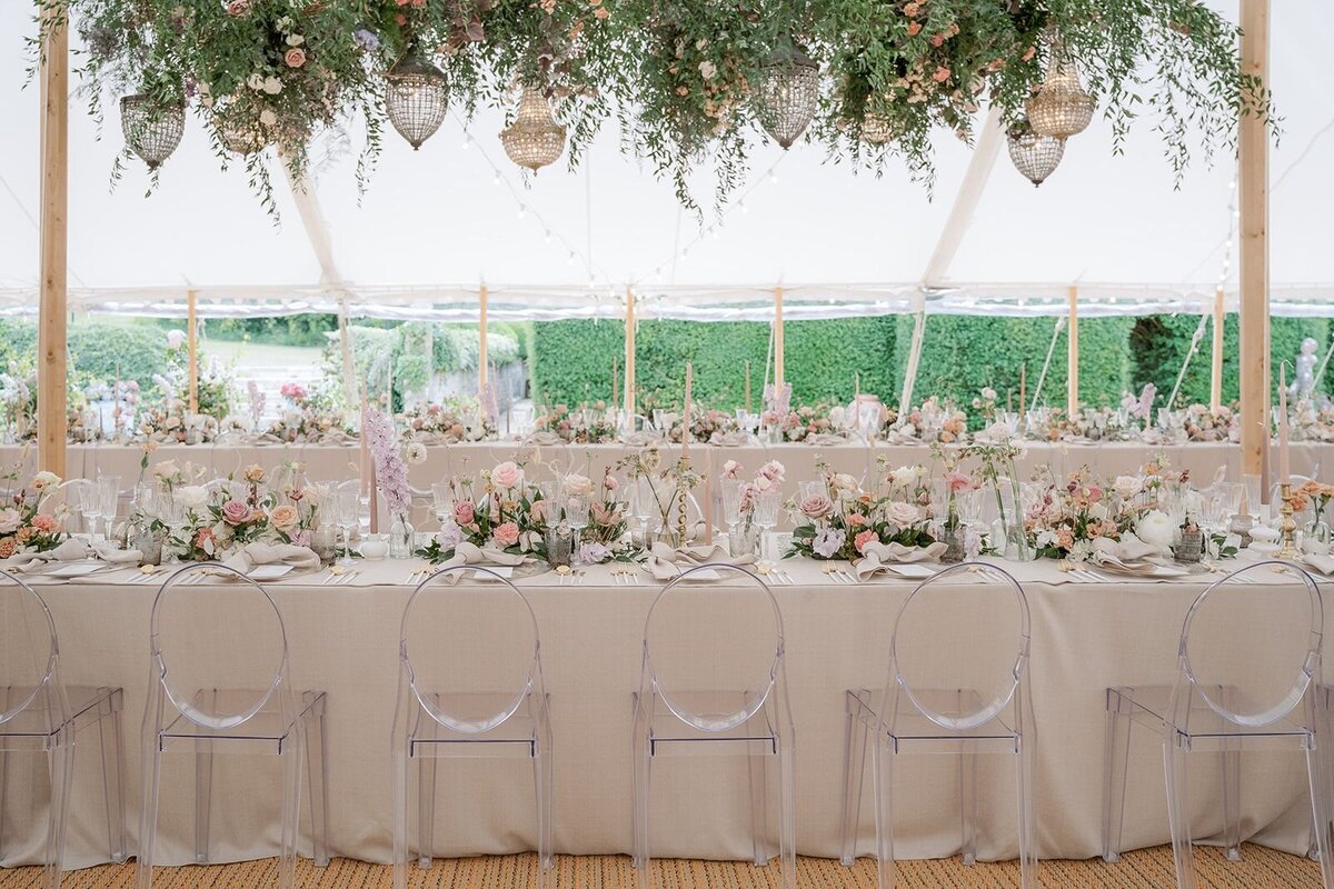 Elegant table display with florals in tented wedding