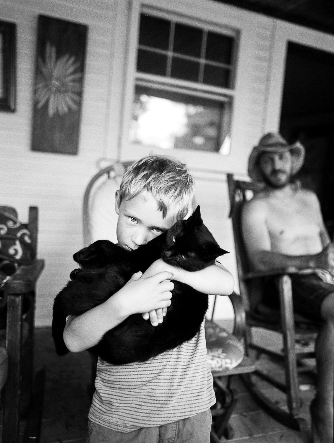 black and white portrait of a son holding cat