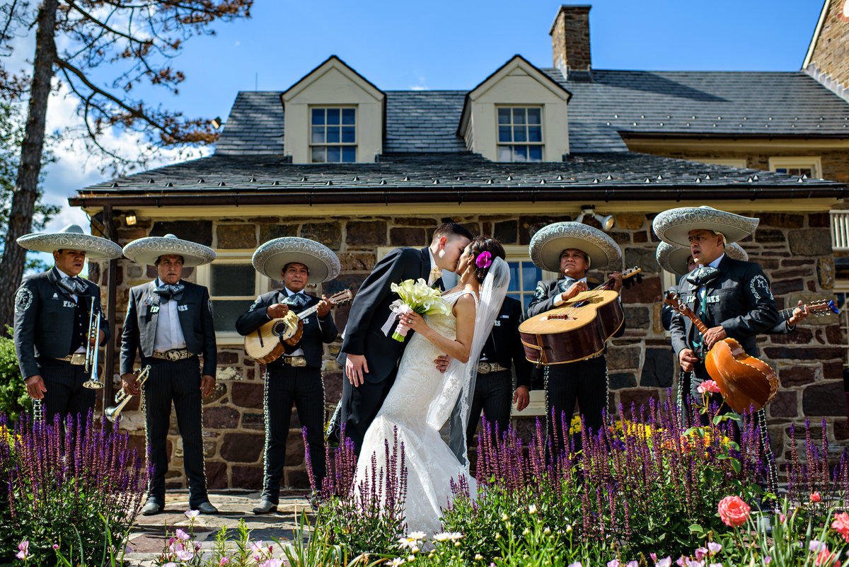 A mariachi band serenade a bride and groom on their wedding day at Pearl S Buck Estate.