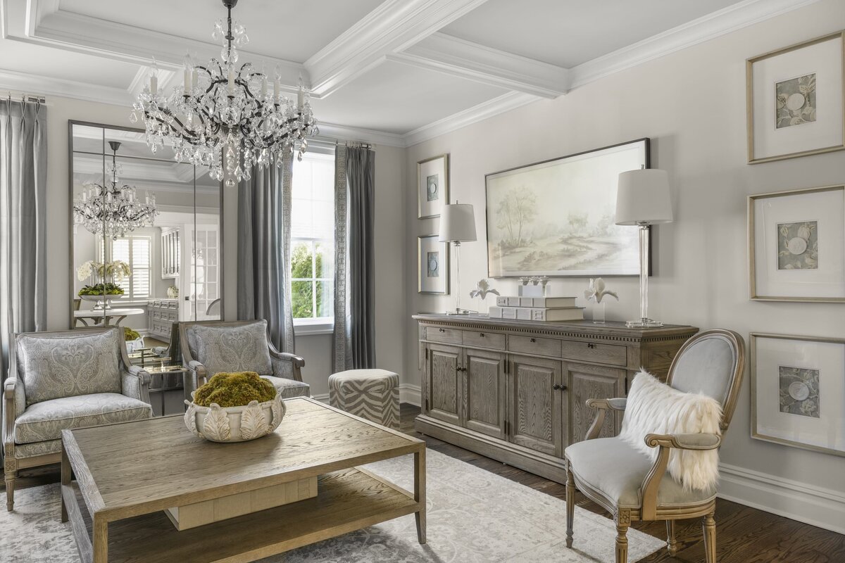 candra lynn interiors ocean port project living room with large chandelier and wooden coffee table