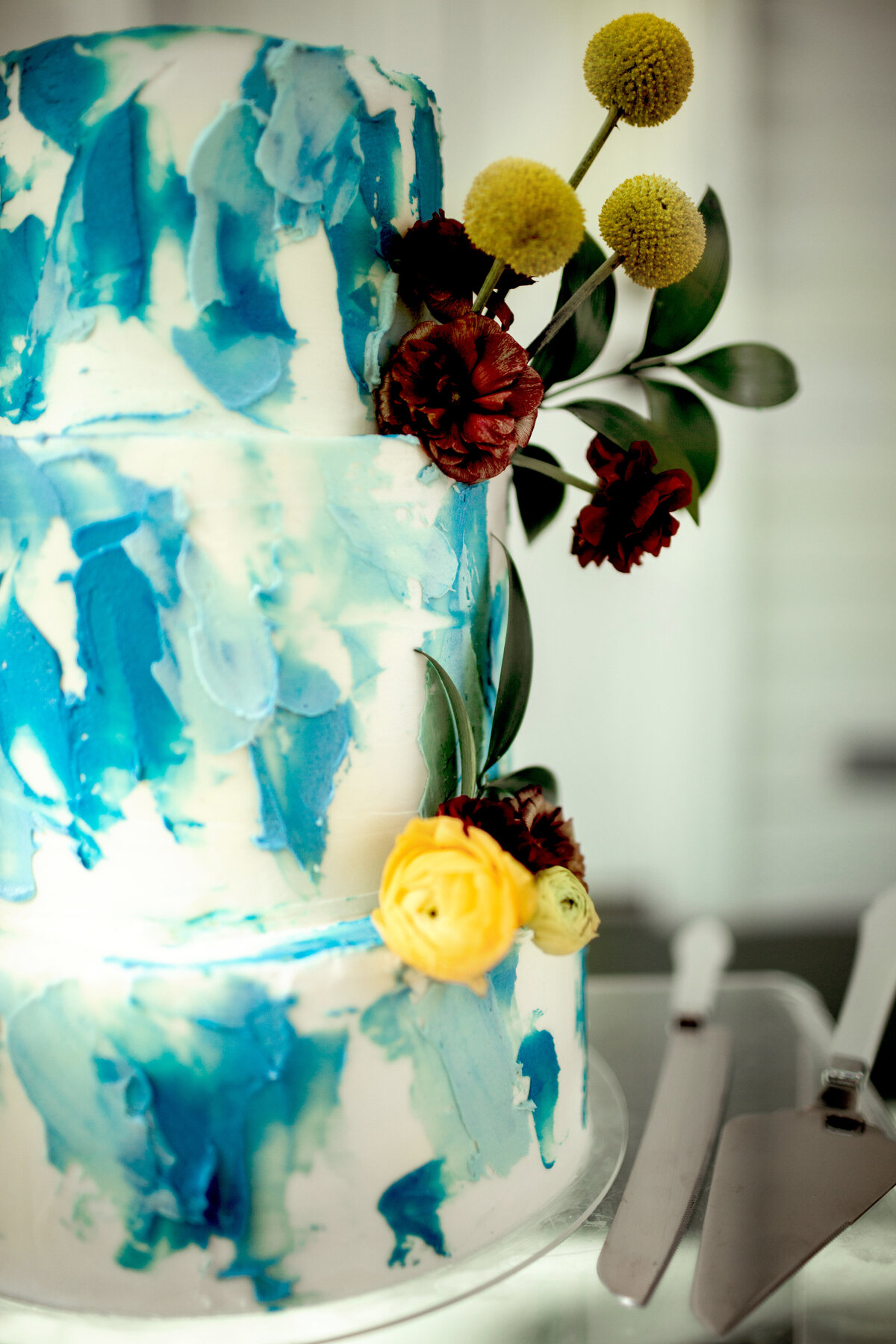 wedding cake blue and white with yellow and red flowers