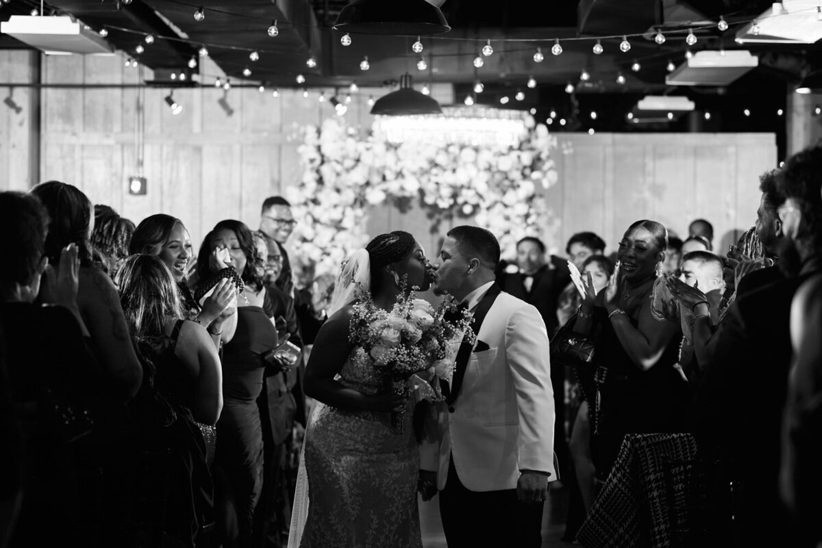 Bride and groom kiss in the aisle 
