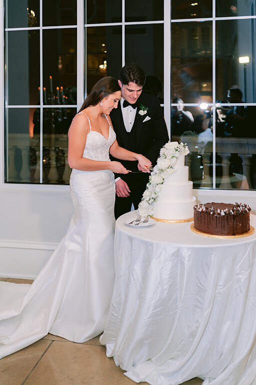 Bride and groom cutting the cake at wedding at The Olana, Dallas