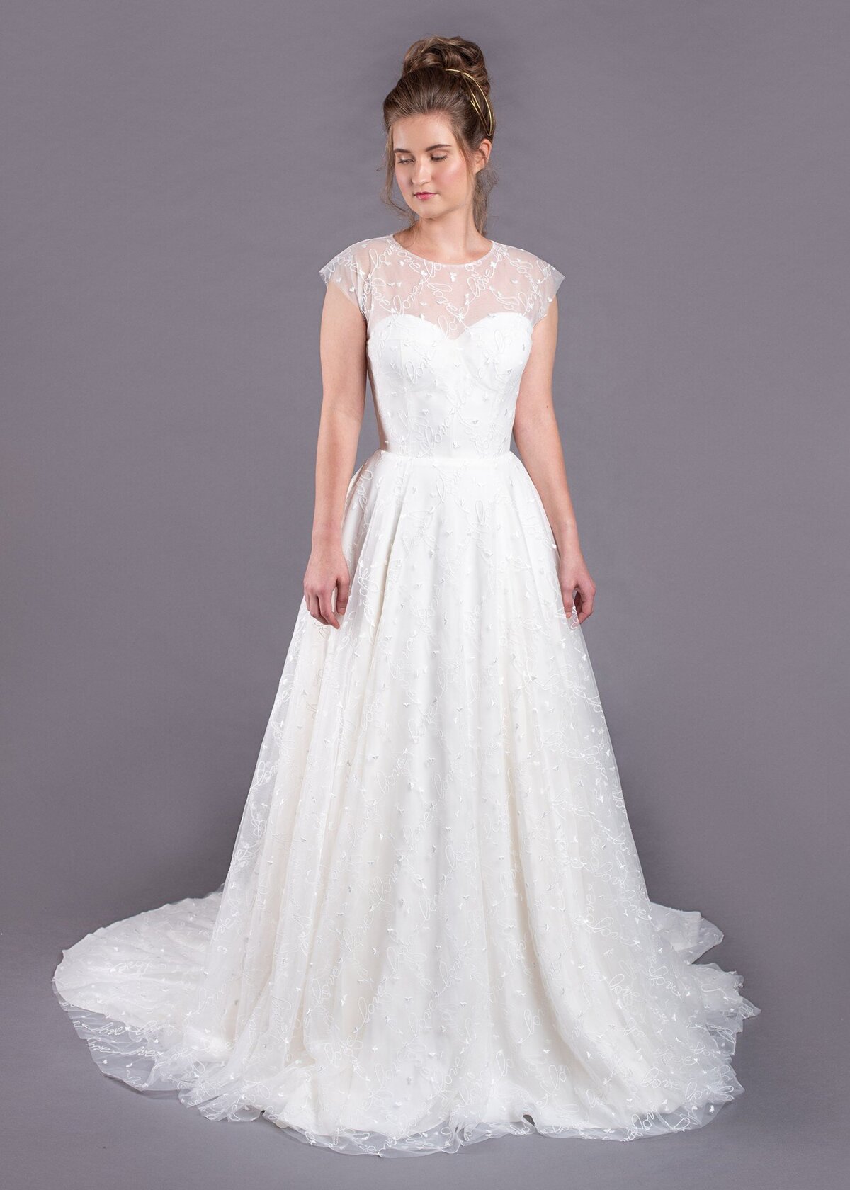 The Norma Jean style from the Edith Elan bridal collection is an illusion neckline wedding dress with love written all over it.