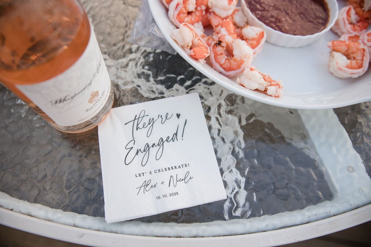 Picture of cocktail napkins with the couple's engagement date.