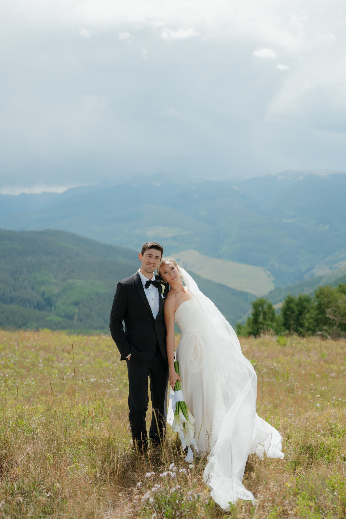 elegant bride and groom on top of vail mountain