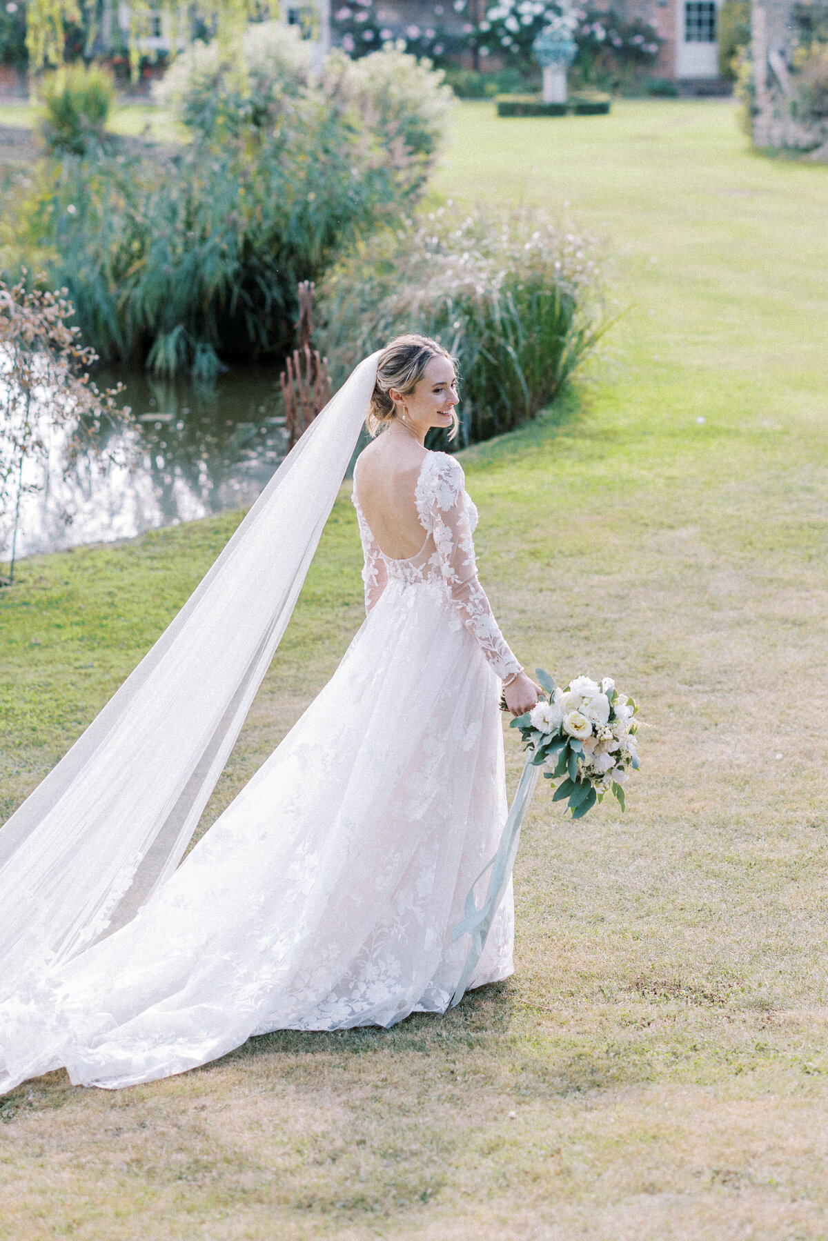 Bride walks in the garden on her wedding day