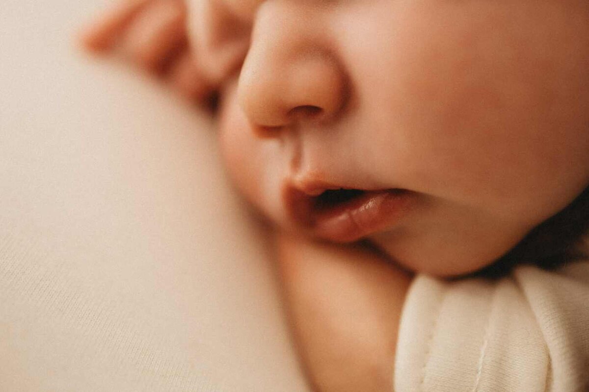 Ruua Hamdan Photography (UK): A very close-up shot of a sleeping baby's mouth and nose. Soft, gentle light
