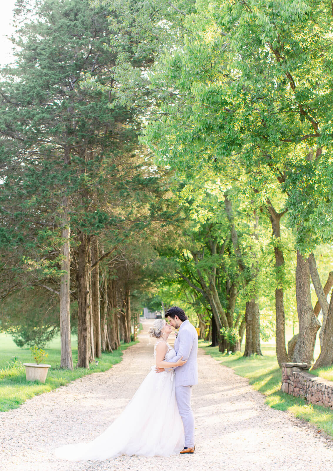 Bride and Groom surrounded by trees during golden hour at Great Marsh Estate.