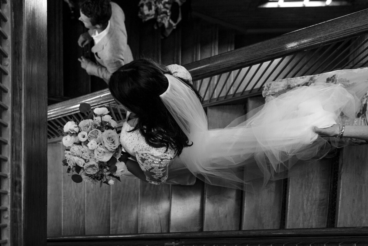 Bride walks down the stairs at Cafe Brauer in Chicago, IL