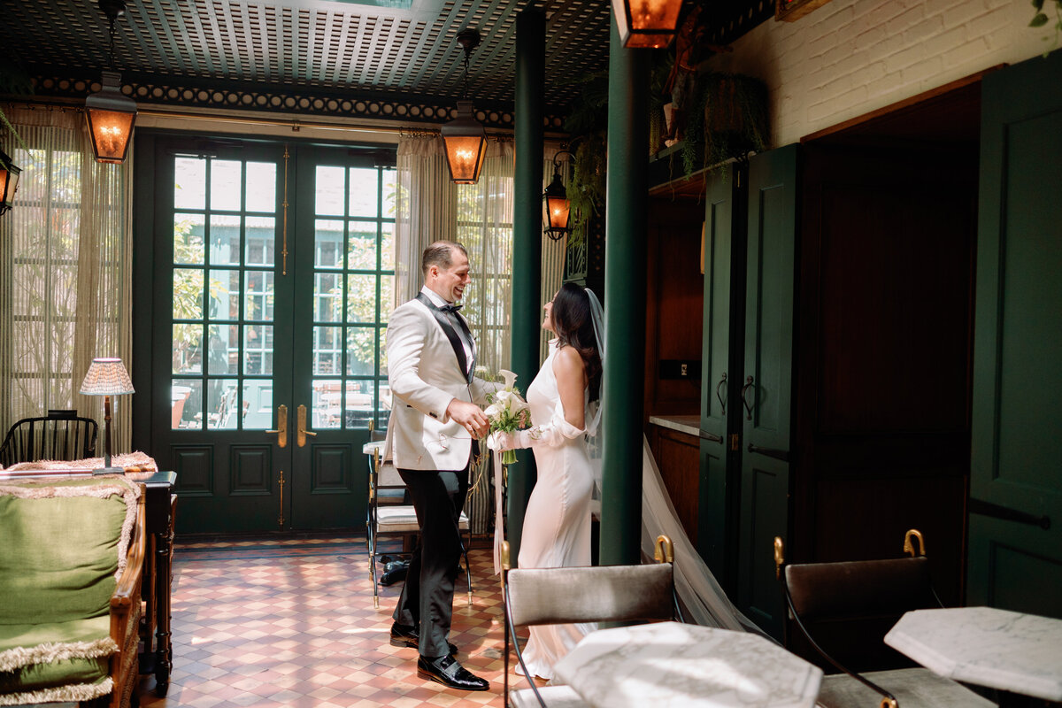 Bride and groom sharing a first look inside Hotel Chelsea in New York City, captured during Japna and Chris’s intimate elopement by NYC wedding photographer Perry Hancock.