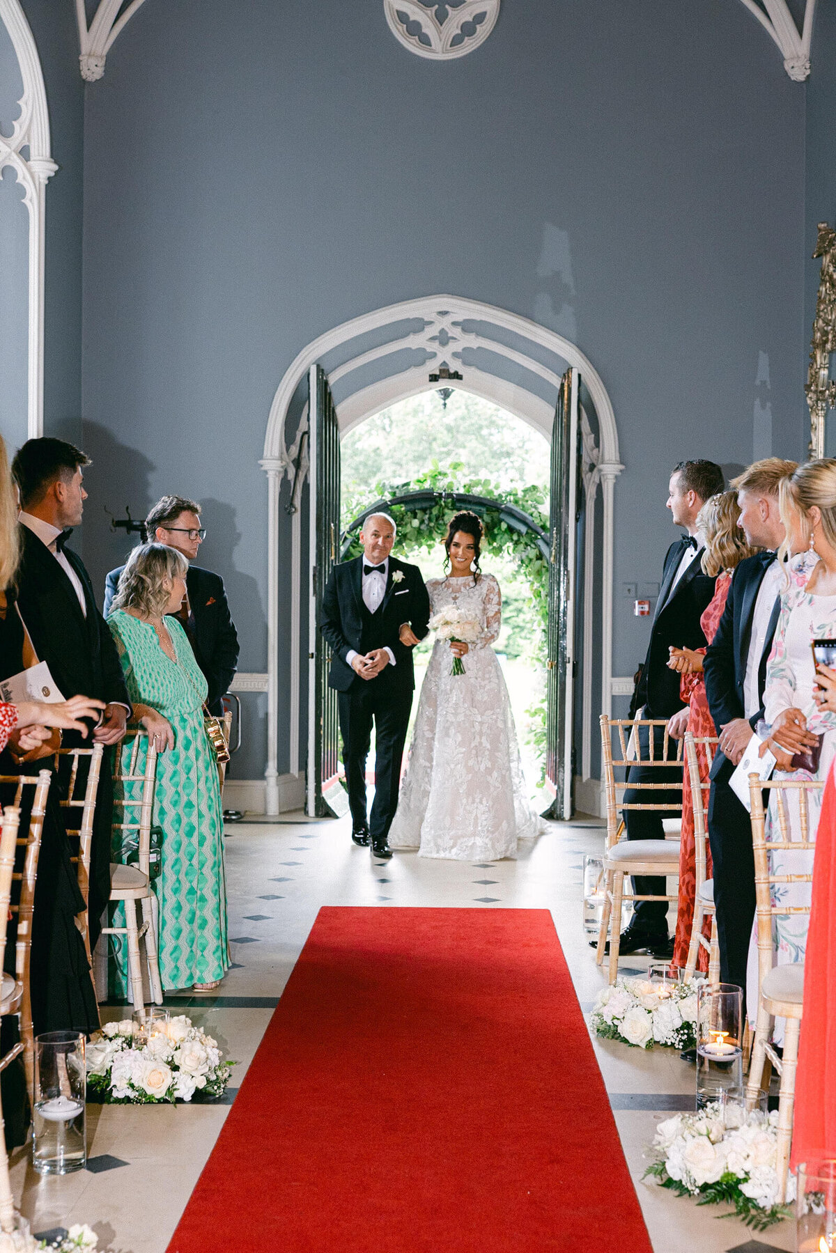 A wedding photo of the bride walking down the aisle