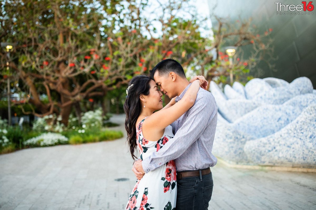 Engaged couple share a tender moment during their engagement photo shoot