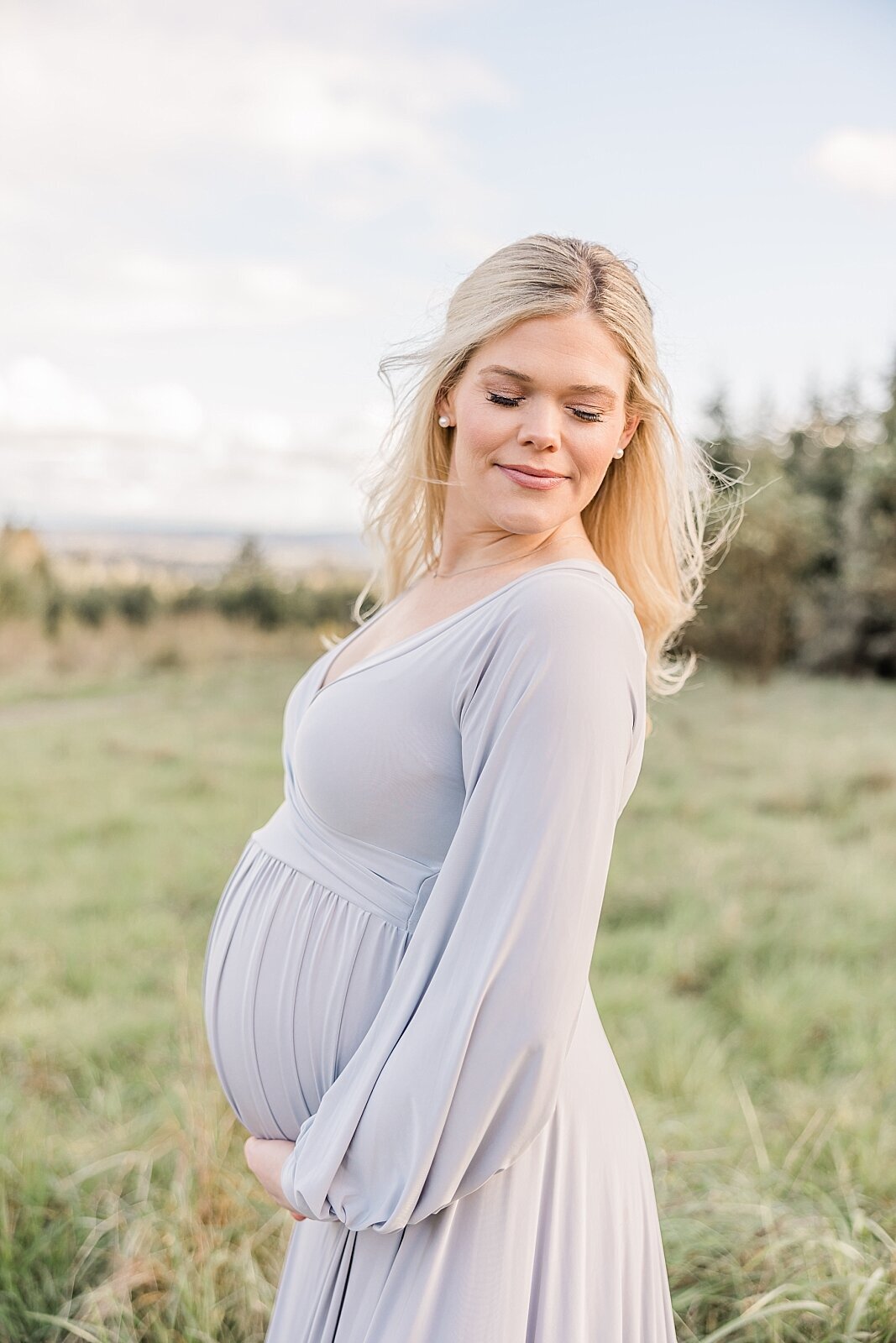 pregnant mom wearing silver dress for maternity photos in beaverton oregon